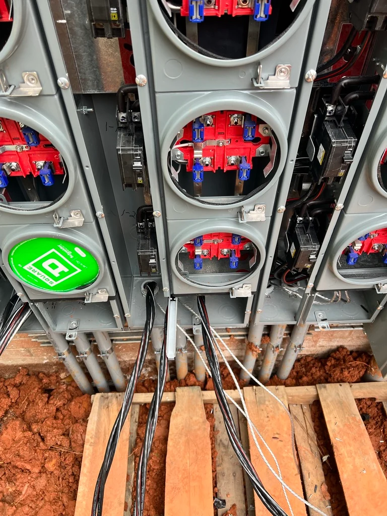 Multiple open meter sockets and service conductors during electrical installation work