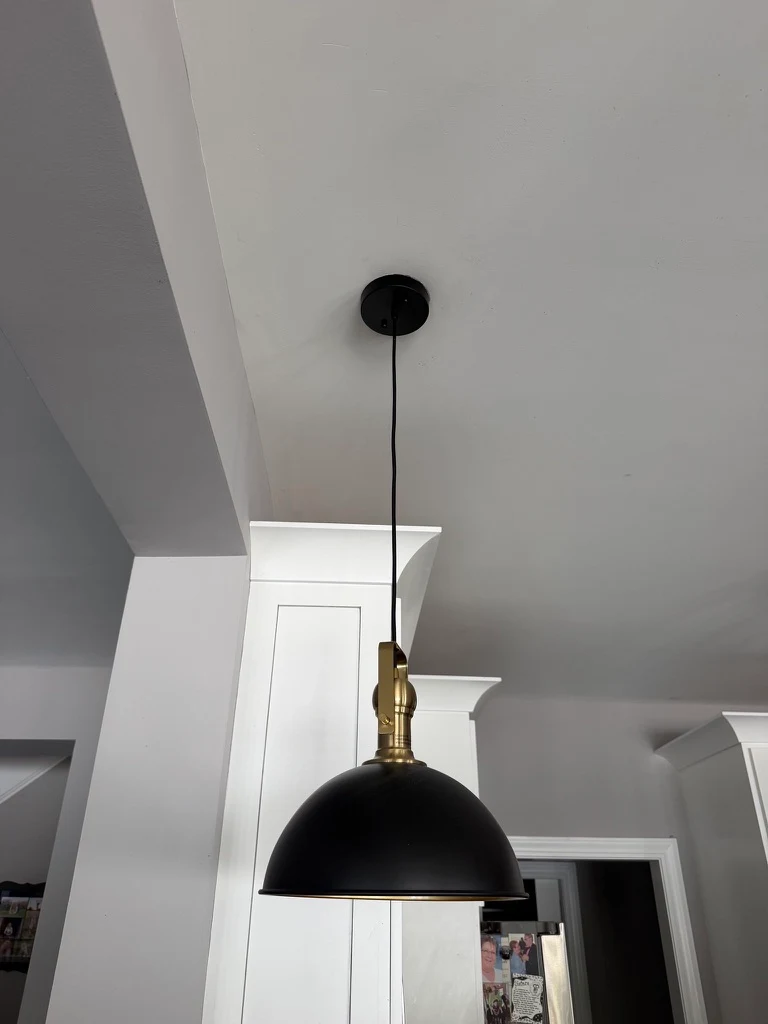 Brass fitting and black pendant installed by Guardian